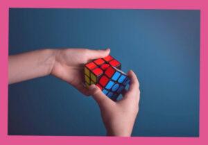 Two hands holding the rubik's cube depicting the resilient mind.